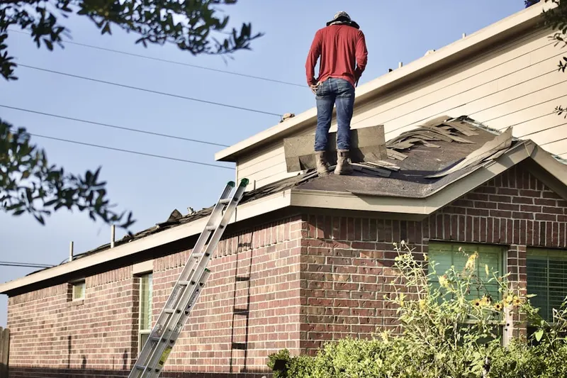 Professional roofer working on a residential roof in North Leominster